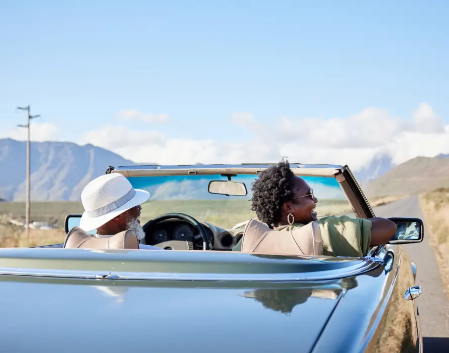Older couple in convertible on a roadtrip